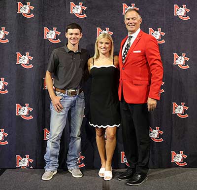 Scholarship recipients College President recognizing two scholarship recipients