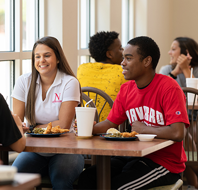 Campus Dining Students talking and eating in dining hall