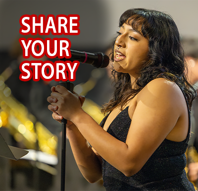 Share Your Story Student singing solo on stage with spotlight