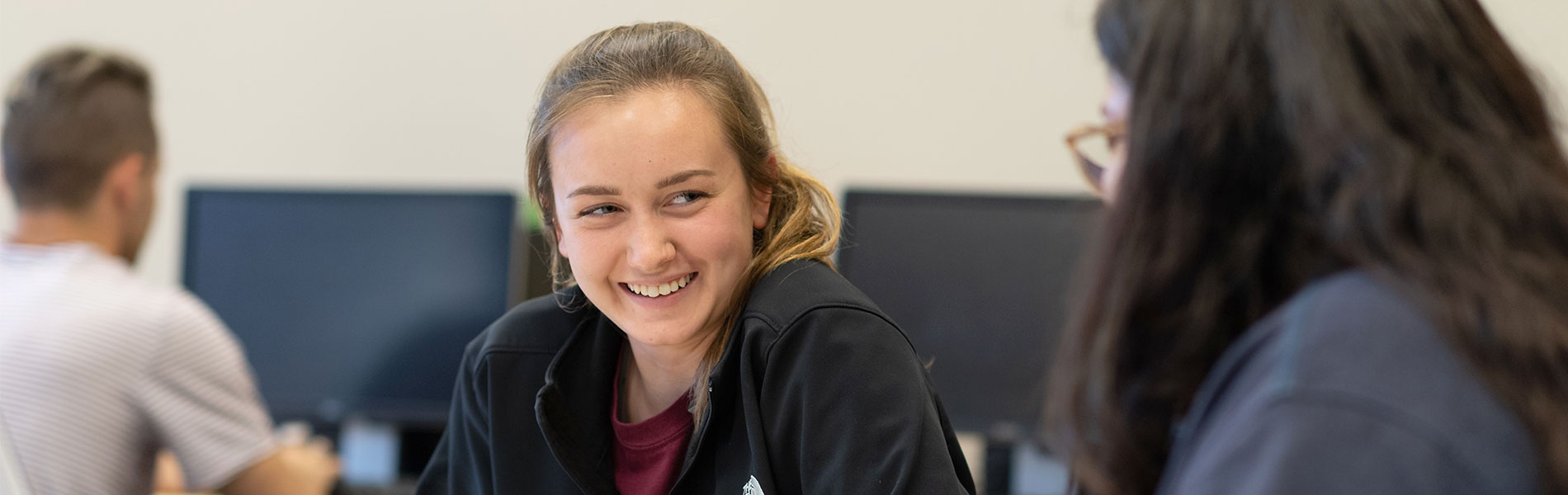 Student smiling in acknowledgment to another student
