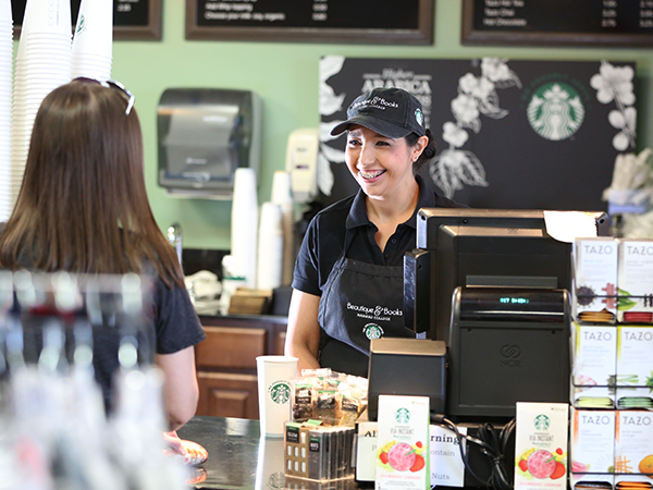 Starbucks Starbucks employee serving coffee at on-campus cafe