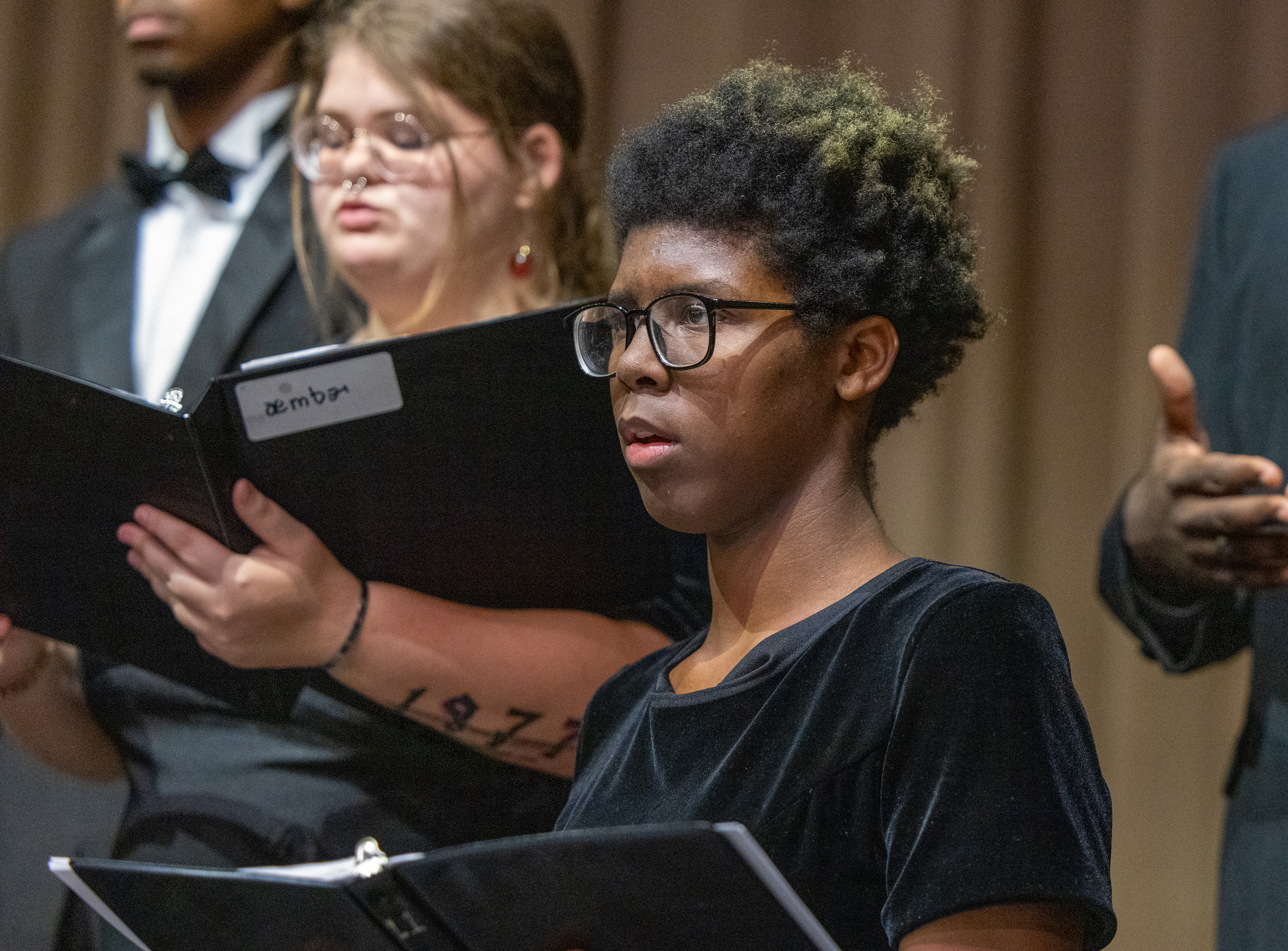 Soloist performing with choir in the background