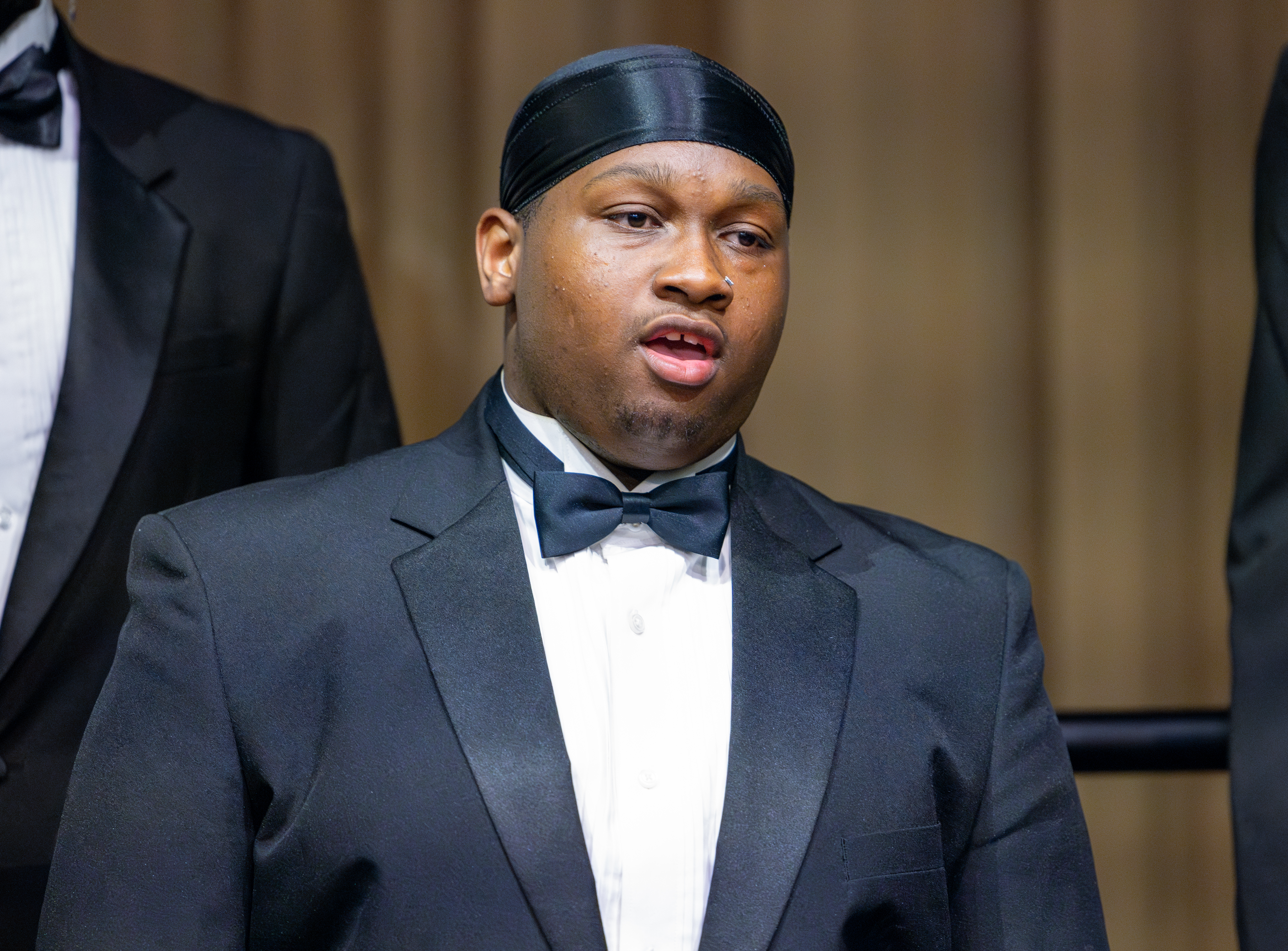 Soloist performing with choir in the background