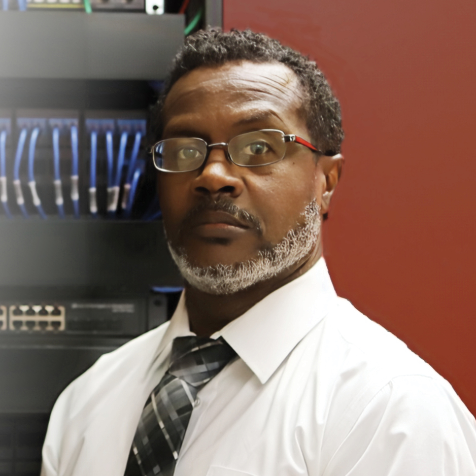 Computer Information Computer Information male employee standing next to data server