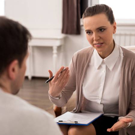 Mental Health Counselor talking to patient in confidential manner