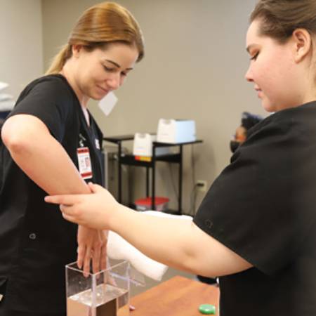Occupational Therapy Student practicing therapy exercises in Occupational Therapy Assistant program