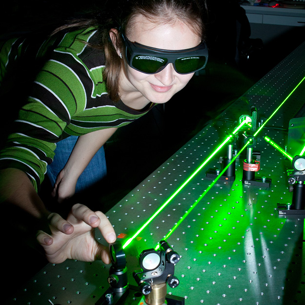Physics Student wearing blackout googles while adjusting laser beams